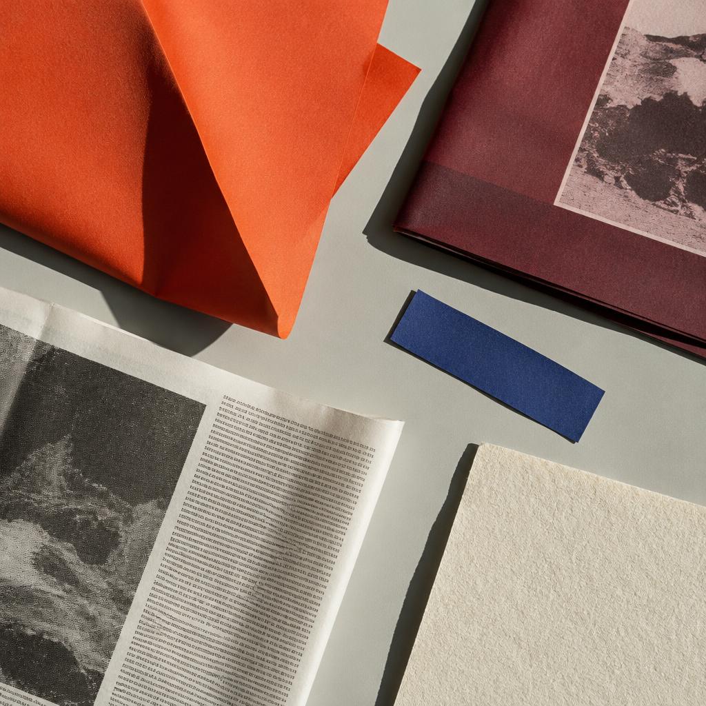 Orange and burgundy printed paper in sunlight